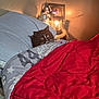 Cal Cal is registered to the contest to win money with this photo: cat, bed, blanket, comforter, pillow, lamp, nightstand, figurine, indoor, cozy, black_and_white_cat, pet, fur, resting, looking, warm_light, sleep, home, cute, relax