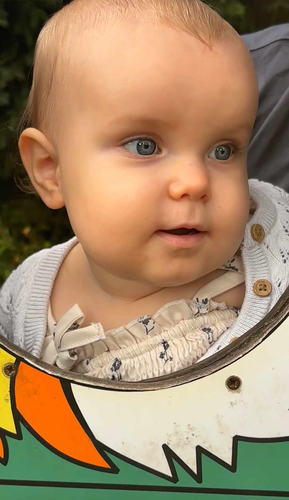 Violet-Rose joined the competition — help win amazing prizes! baby, child, face, blue_eyes, curious, cute, knitted_sweater, floral_outfit, outdoor, portrait, close_up, skin, cheeks, button, colorful_board, playground, nature, person, head, expression