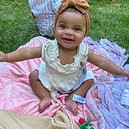 Laila joined the competition — help win amazing prizes! baby, child, girl, smiling, headband, bow, dress, blanket, grass, outdoor, boy, chair, wood, happy, person, playing, picnic, toy, foot, nature