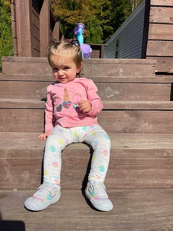 Raelynn is registered to the contest to win money with this photo: baby_toddler_clothing, child, fun, grass, happy, knee, leisure, magenta, person, pink, plant, purple, sitting, sleeve, smile, sock, sportswear, thigh, toddler, tree