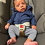 baby, infant, car_seat, blue_hoodie, striped_pants, barefoot, child, seatbelt, curious, indoors, young, portrait, small_hands, tiny_toes, casual_clothing, comfortable, safety, seat, expression, cute