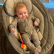 Grayson joined the competition — help win amazing prizes! baby, infant, baby_rocker, onesie, smiling, toy, carpet, indoor, face, person, child, clothing, seat, comfort, home, vertical_blinds, pattern, footed_pajamas, happy, young_child