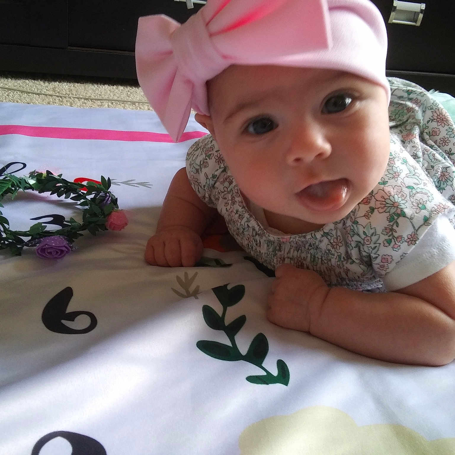 Kaci is registered to the contest to win money with this photo: baby, baby_toddler_clothing, child, finger, fun, hand, head, headgear, headwear, person, play, smile, toddler, tummy_time