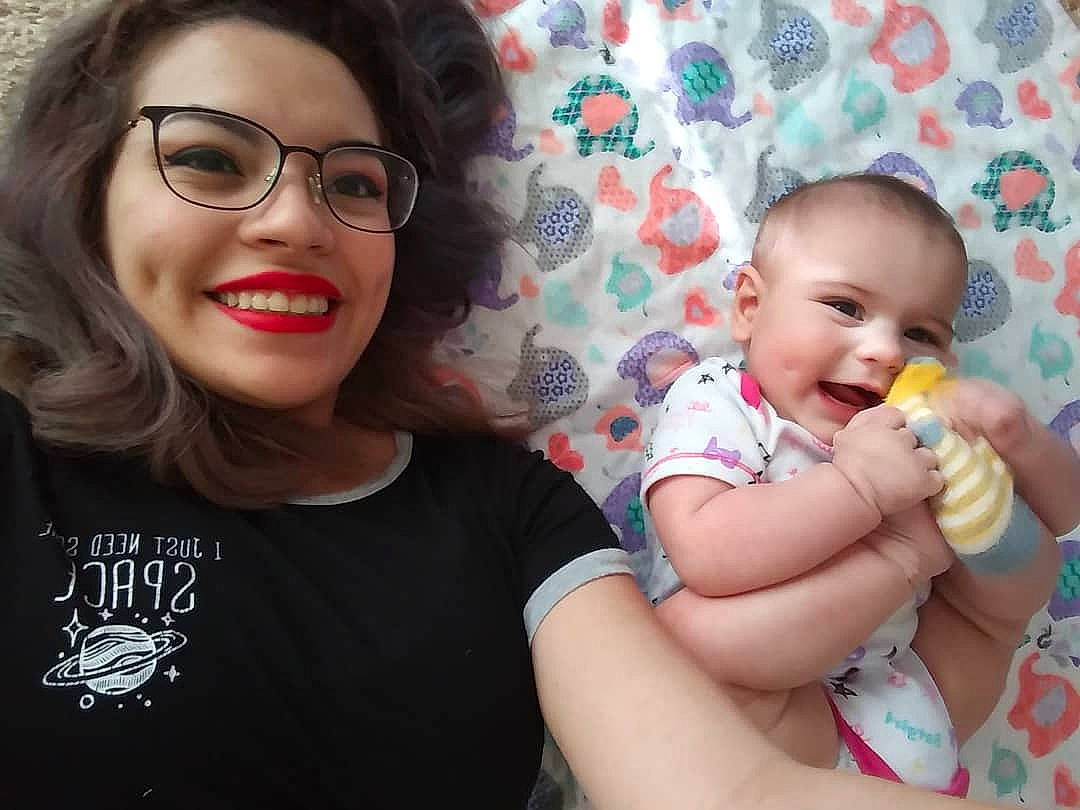 Kaci is registered to the contest to win money with this photo: baby, child, daughter, eating, eyewear, face, food, fun, glasses, happy, joy, lip, mother, nose, person, photography, play, selfie, sibling, smile