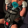 Augustus joined the competition — help win amazing prizes! baby, car_seat, pacifier, mittens, infant, child, seatbelt, safety_harness, closeup, newborn, cute, portrait, indoor, soft_lighting, human, person, skin, head, arm, leg