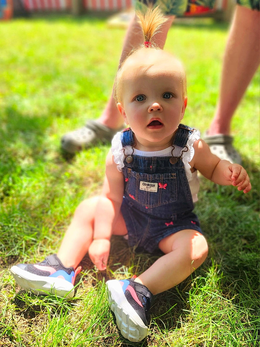 Caroline joined the competition — help win amazing prizes! baby_toddler_clothing, child, footwear, fun, grass, grassland, happy, human_leg, joint, lawn, leg, leisure, people_in_nature, person, recreation, sandal, shoe, shorts, sneakers, thigh