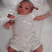 Khadija joined the competition — help win amazing prizes! baby, infant, lying_down, white_clothing, shorts, socks, cute, face, eyes, lips, cheeks, handwritten_text, stars, clouds, bed, soft_texture, portrait, child, adorable, sleepwear