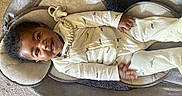 Chase joined the competition — help win amazing prizes! baby, infant, smile, face, onesie, dinosaur_pattern, pacifier, pacifier_clip, baby_lounger, cushion, carpet, indoor, child, cute, happy, person, sleepwear, lying_down, young_child, cozy
