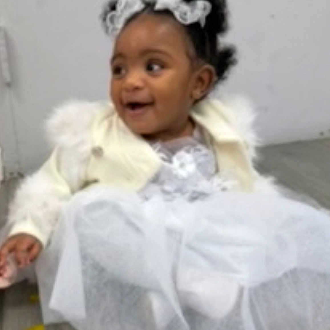 Jaliyah joined the competition — help win amazing prizes! baby, child, curly_hair, cute, dress, fashion, floor, girl, happy, indoors, jacket, lace_bows, person, portrait, sitting, smiling, toddler, white_dress, wooden_floor, young_child