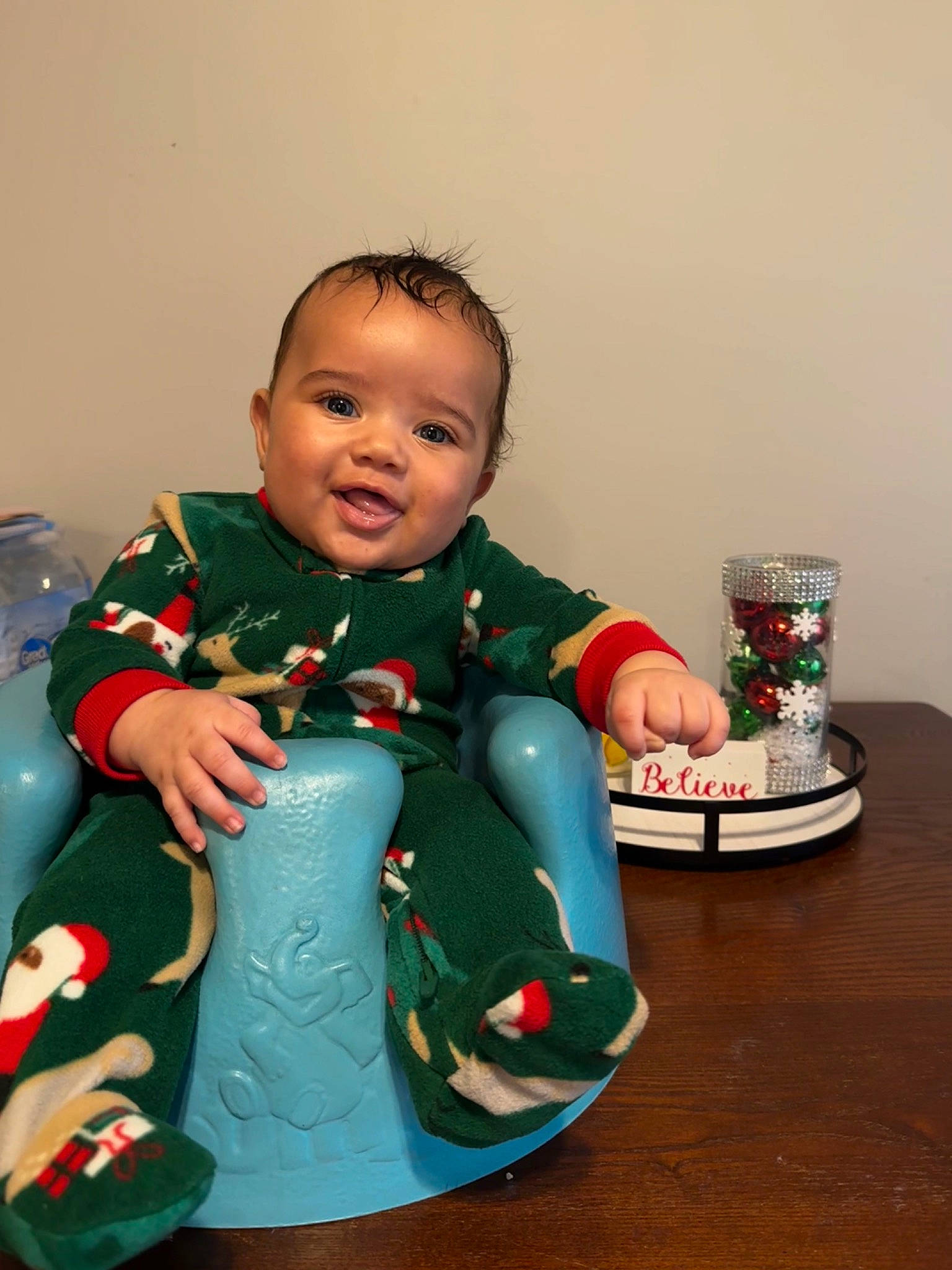 Jakai is registered to the contest to win money with this photo: baby, baby_toddler_clothing, cheek, christmas, christmas_decoration, christmas_eve, christmas_ornament, event, fictional_character, flooring, fun, happy, head, holiday, person, room, sitting, sleeve, smile, toddler