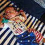 Zayden joined the competition — help win amazing prizes! baby, infant, pacifier, clothing, striped_blanket, blue_shorts, stars, stripes, patriotic, 4th_of_july, sleeping, lying_down, cute, child, toddler, indoors, soft_texture, resting, celebration, happy