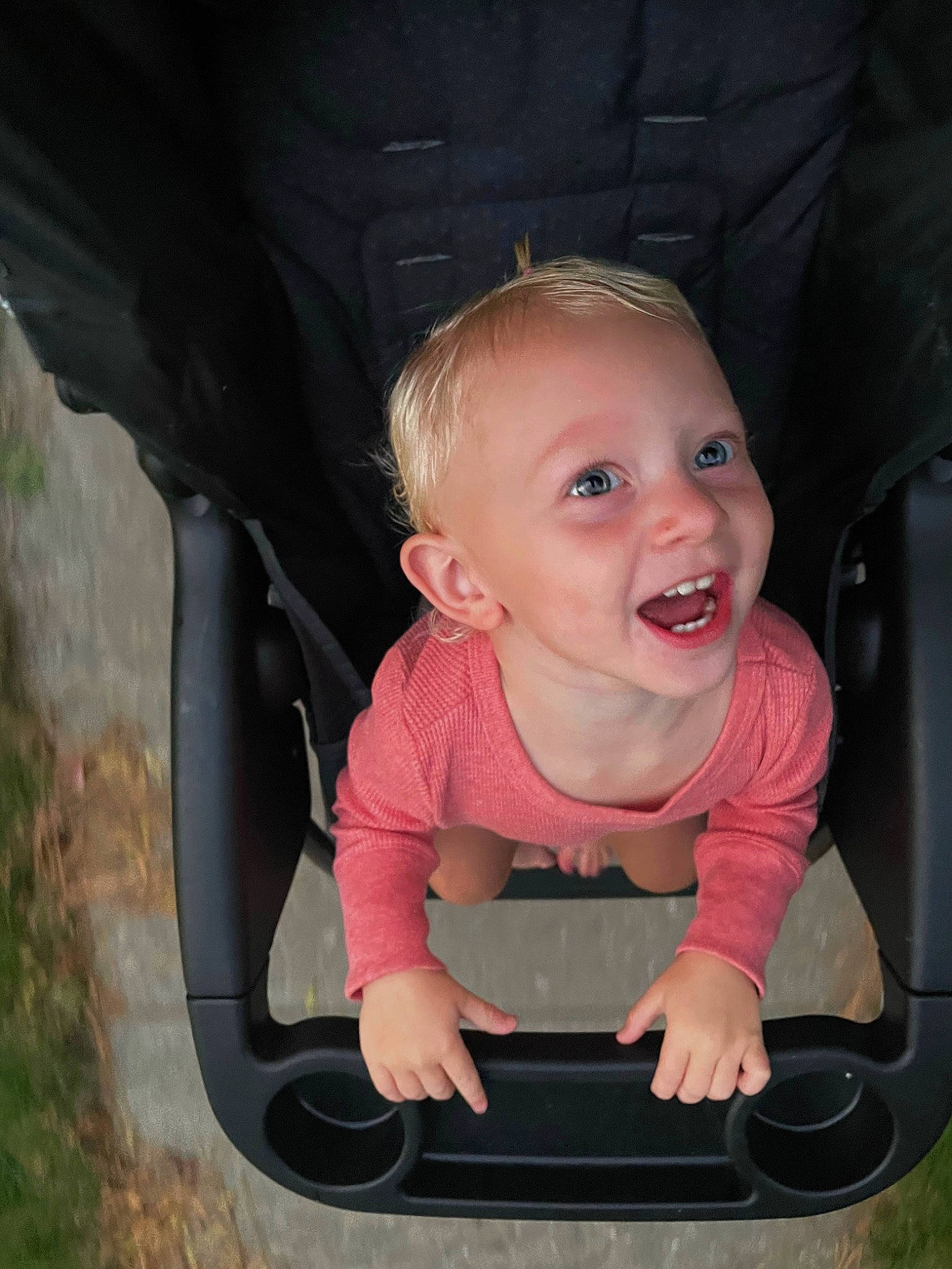Eden is registered to the contest to win money with this photo: automotive_exterior, automotive_lighting, automotive_mirror, eye, flash_photography, grass, happy, head, motor_vehicle, mouth, organ, person, photograph, pink, plant, product, skin, smile, toddler, vehicle_door