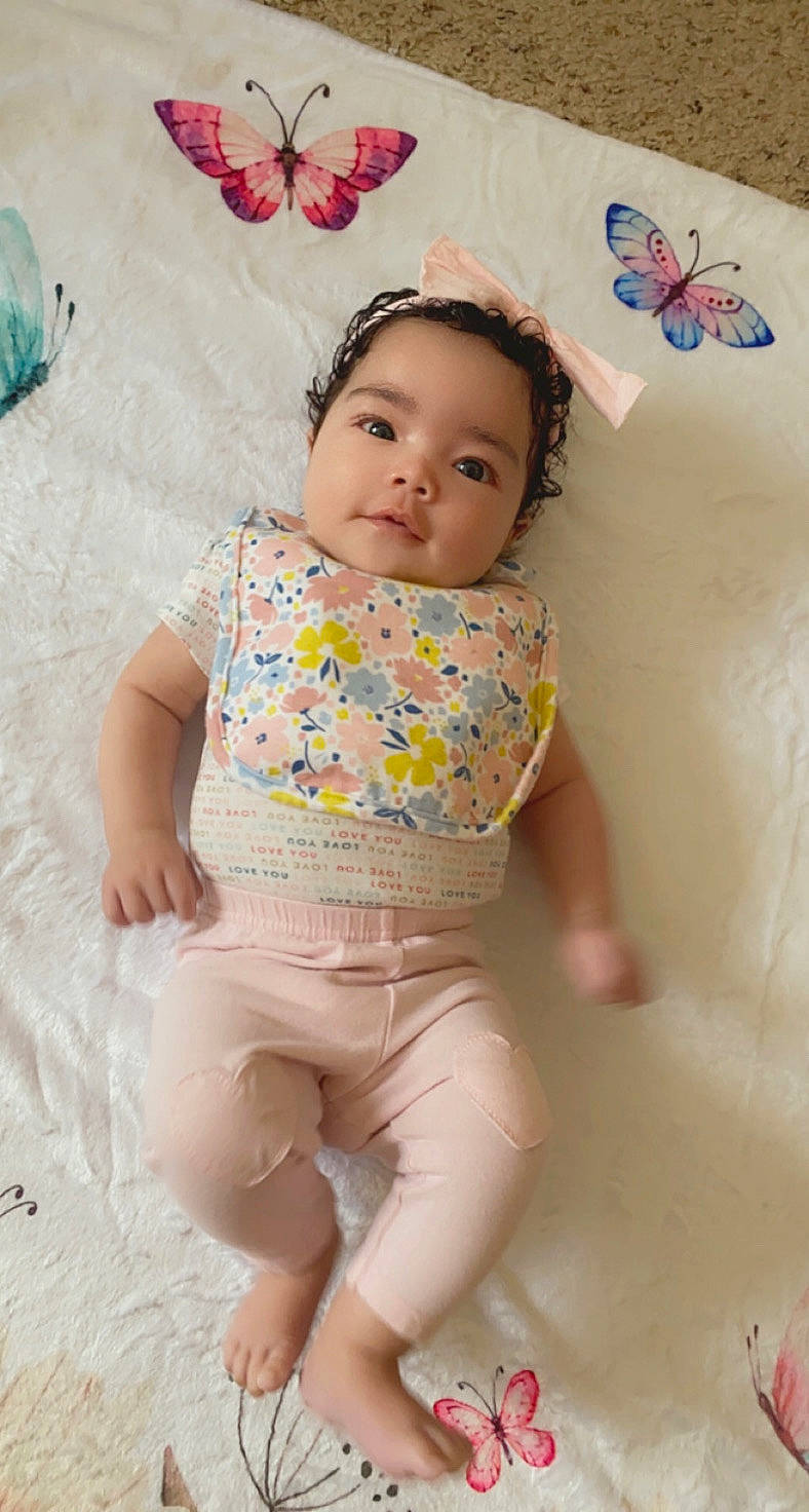 Journi is registered to the contest to win money with this photo: baby, baby_toddler_clothing, butterfly, comfort, eye, face, happy, head, iris, leg, person, pink, pollinator, product, skin, sleeve, stomach, t_shirt, textile, toddler