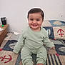 baby, bed, child, cozy, cute, expression, face, feet, furniture, happy, head, indoor, infant, pajamas, pattern, person, quilt, room, sitting, smiling