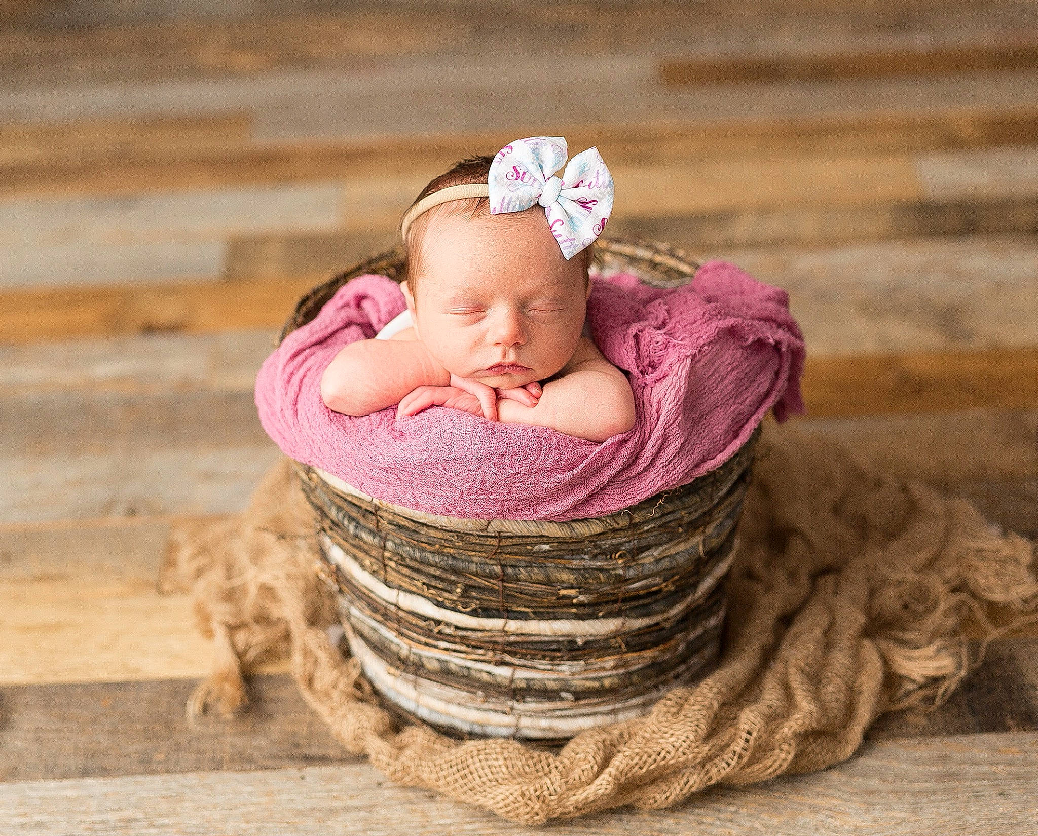 Sutton is registered to the contest to win money with this photo: baby, baby_products, baby_toddler_clothing, basket, cap, comfort, eye, face, grass, hair_accessory, happy, headband, headgear, headpiece, jewellery, people_in_nature, person, pink, sitting, toddler
