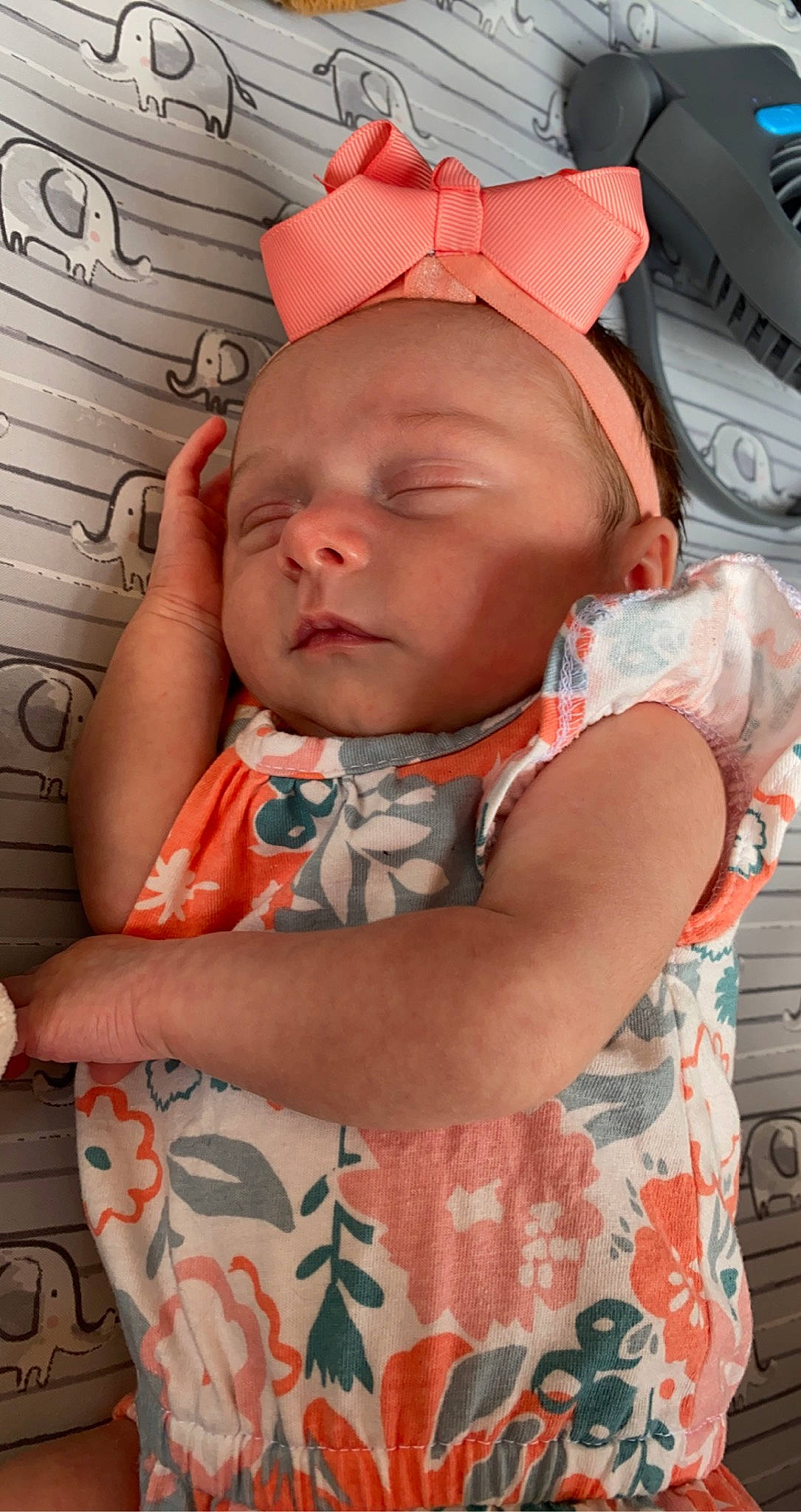 Sutton is registered to the contest to win money with this photo: baby, baby_carriage, baby_toddler_clothing, cheek, child, comfort, eye, fun, happy, iris, lip, mouth, neck, nose, orange, organ, person, pink, red, skin