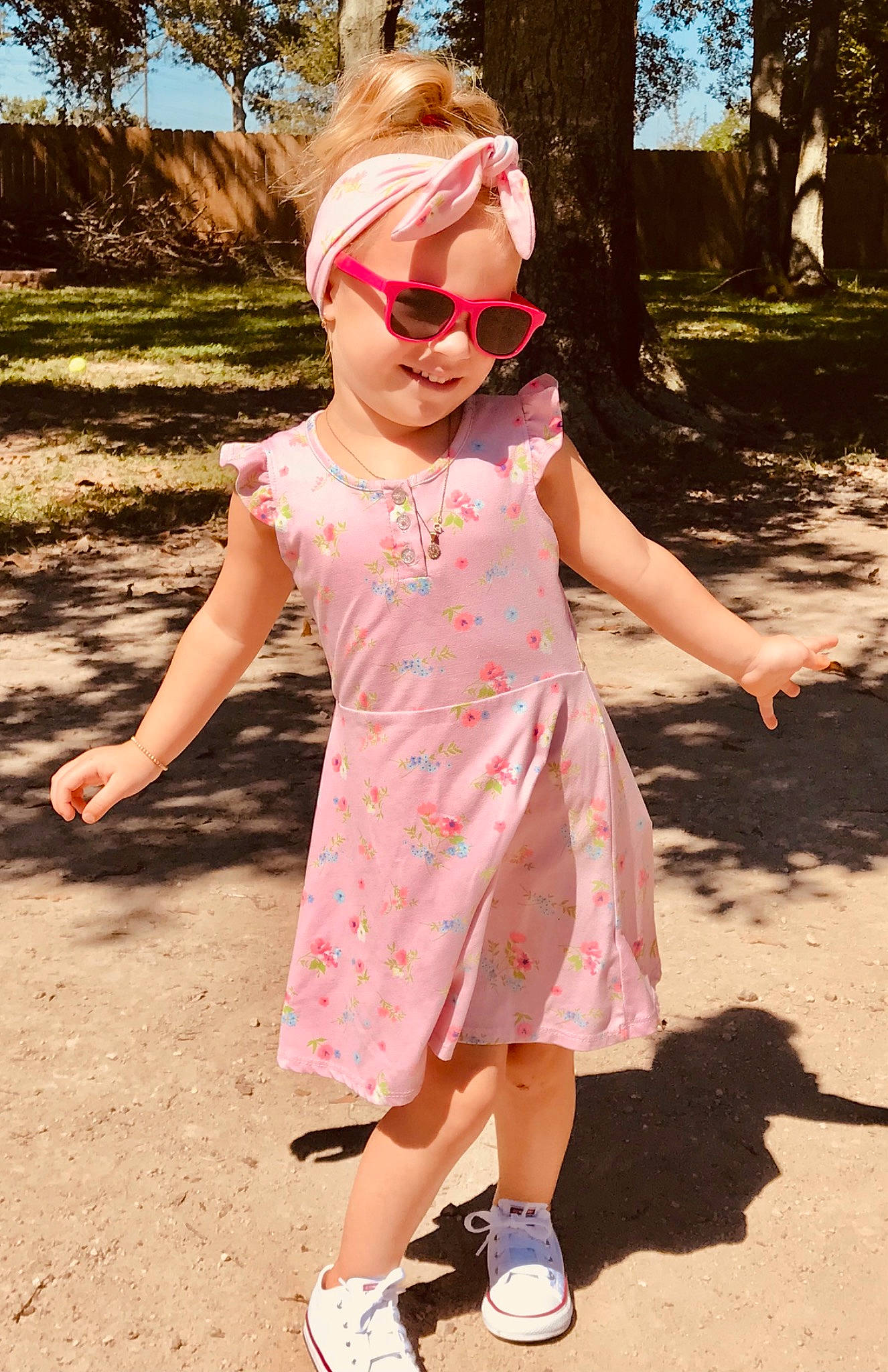 Mckenzie joined the competition — help win amazing prizes! baby_toddler_clothing, day_dress, dress, face, gesture, glasses, goggles, grass, happy, leaf, one_piece_garment, people_in_nature, person, pink, plant, skin, sleeve, sunglasses, tree, vision_care