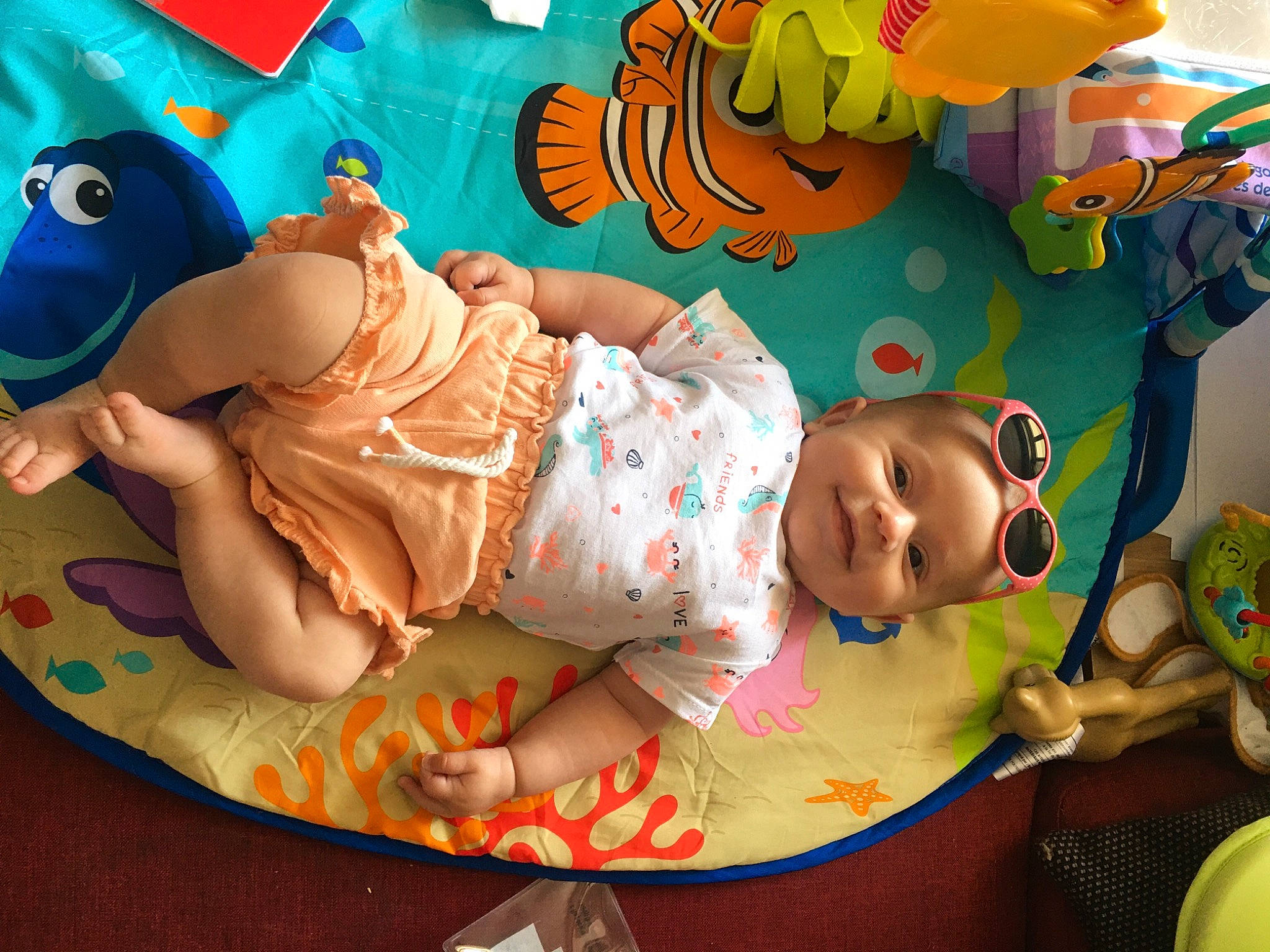 Olivia participe au concours pour gagner de l'argent avec cette photo : baby, baby_products, baby_toddler_clothing, baby_toys, baseball_cap, cap, child, fun, happy, hat, joy, leisure, linens, mouth, pattern, person, play, product, room, smile