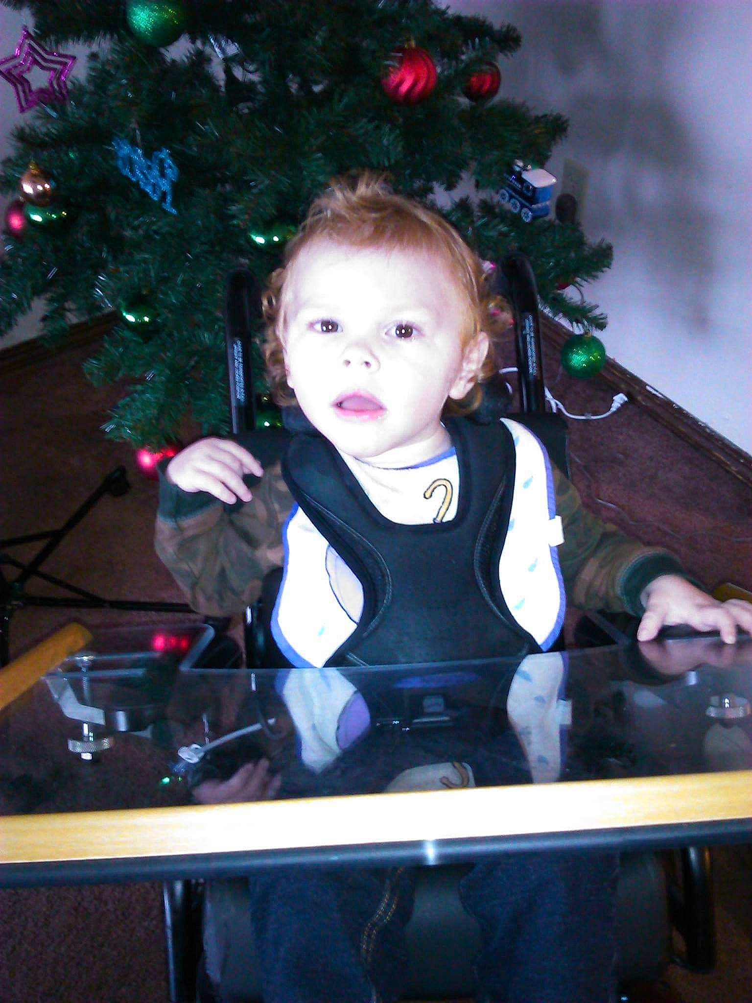 Andrew joined the competition — help win amazing prizes! baby, baby_toddler_clothing, christmas_ornament, christmas_tree, conifer, event, flash_photography, formal_wear, fun, happy, head, holiday, holiday_ornament, iris, ornament, person, room, sitting, sleeve, standing