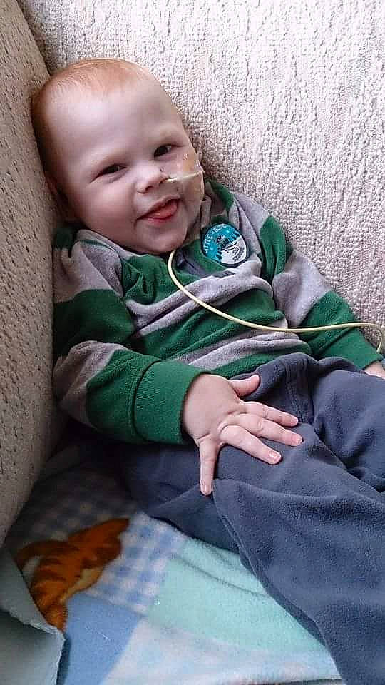 Andrew is registered to the contest to win money with this photo: baby, baby_products, baby_toddler_clothing, cheek, child, comfort, eye, face, finger, grass, hand, happy, head, linens, person, sitting, skin, sleeve, smile, textile