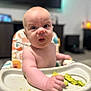 Elliott joined the competition — help win amazing prizes! baby, high_chair, food, messy, face, infant, child, eating, home, indoor, feeding, curious, expression, hands, tray, seat, person, young, cute, skin