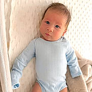 Jennings joined the competition — help win amazing prizes! baby, infant, onesie, blue_clothing, blanket, soft_texture, face, skin, cute, newborn, lying_down, indoors, portrait, baby_bed, curious, head, eyes, small_hands, cozy, resting