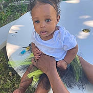 Saiaura is registered to the contest to win money with this photo: baby, child, outdoor, table, white_shirt, tutu, flower_hair_clip, grass, hands, person, curious, skin, feet, legs, holding, sunlight, shadow, nature, face, portrait