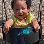 Jalaiya joined the competition — help win amazing prizes! adult, black_swing, casual_clothing, child, daylight, fun, grass, hair_ties, happy, outdoor, park, person, play, playground, recreation, smile, swing, toddler, woodchips, yellow_shirt