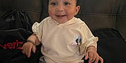 Jalaiya is registered to the contest to win money with this photo: baby, casual, child, clothing, couch, cute, happy, home, indoors, leather, minnie_mouse, natural_light, person, shorts, sitting, smiling, toddler, topknot, white_shoes, window
