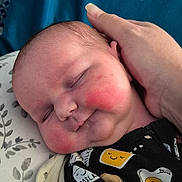 Anara is registered to the contest to win money with this photo: baby, infant, sleeping, hand, rosy_cheeks, pillow, blue_background, onesie, patterned_clothing, cute, peaceful, resting, child, portrait, indoor, soft_light, newborn, person, smiling_eggs, toast