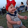 baby, casual, child, daylight, family, grass, happy, headband, holding, infant, lawn_chairs, outdoor, people, person, portrait, red_bow, smiling, striped_clothing, summer, tattoo