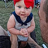 adult, baby, blue_collar, casual, child, curious, cute, family, fun, grass, holding, infant, lawn_chair, outdoor, people, portrait, red_bow, striped_clothing, summer, tattoo