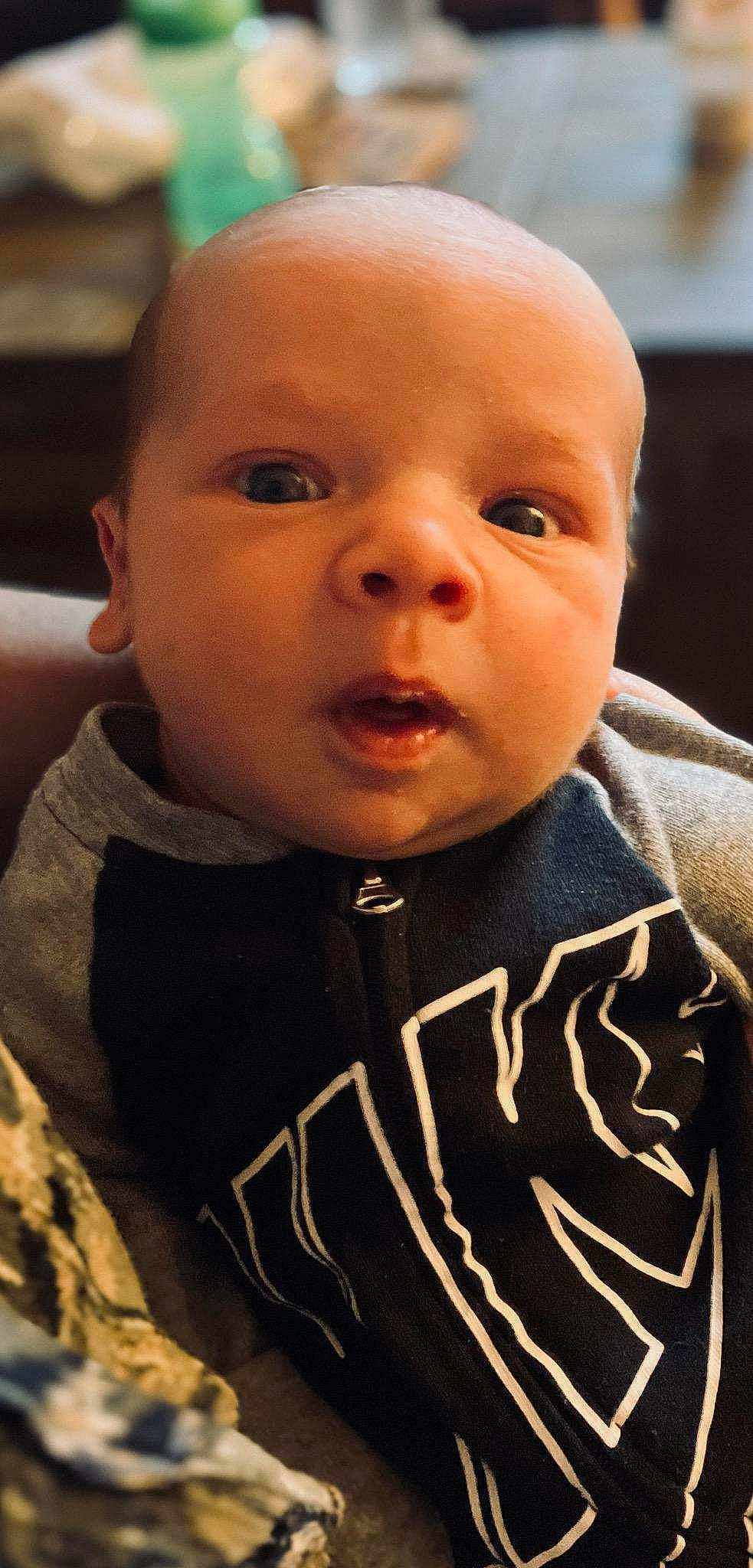 Knox is registered to the contest to win money with this photo: baby, baby_toddler_clothing, cheek, chin, cool, ear, eyebrow, eyelash, face, facial_expression, forehead, human, iris, jaw, lip, mouth, neck, nose, person, skin