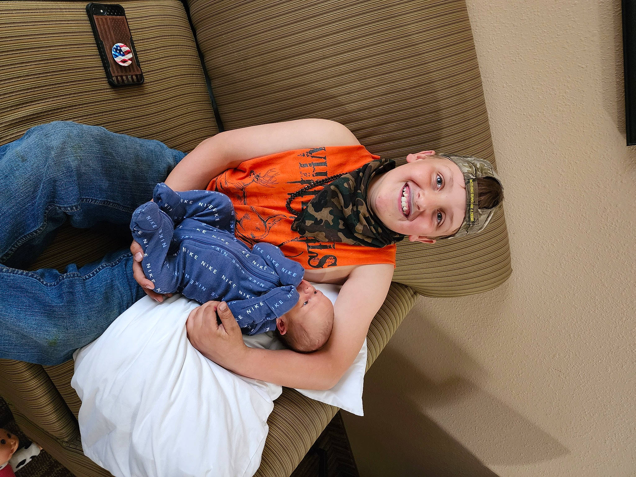 Camden is registered to the contest to win money with this photo: chair, child, comfort, couch, denim, flash_photography, fun, happy, headwear, human_leg, joy, knee, lap, leisure, linens, nap, person, room, sitting, smile