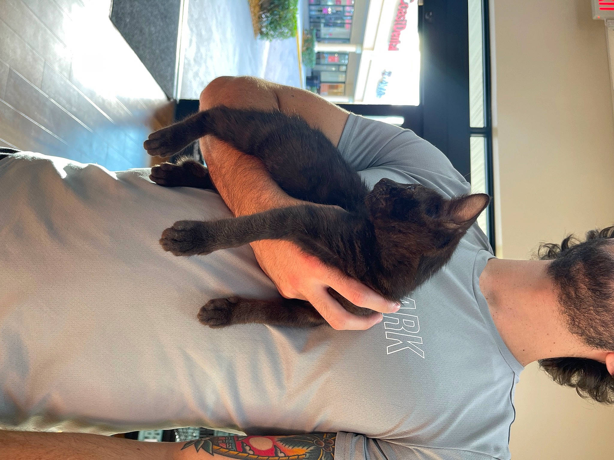 Moose is registered to the contest to win money with this photo: abdomen, beard, bed, chest, comfort, elbow, gesture, human_leg, joint, knee, leg, shoulder, sleeve, t_shirt, tattoo, textile, thigh, trunk, wood, wrist