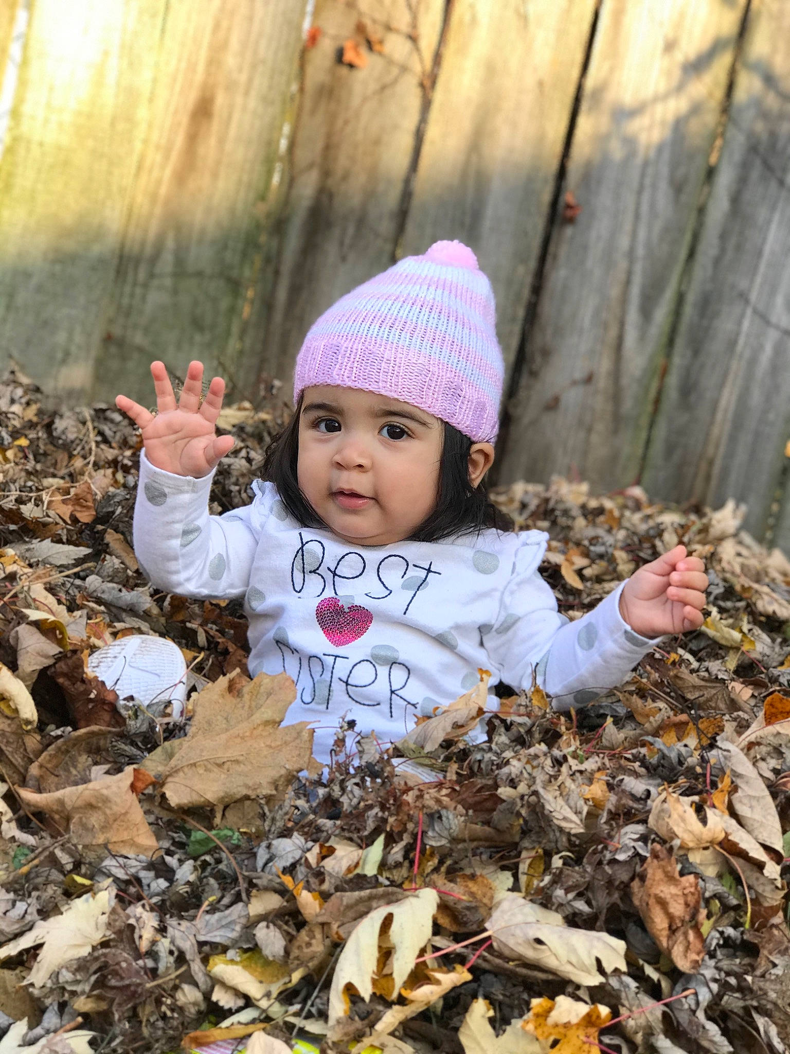Kendra is registered to the contest to win money with this photo: autumn, baby, beanie, cap, child, headgear, headwear, leaf, person, plant, play, smile, toddler