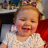 Zayleigh joined the competition — help win amazing prizes! baby, child, smiling, face, polka_dot, bow, clothing, happy, indoor, person, cute, infant, red_cheeks, portrait, short_sleeve, headwear, young_child, closeup, skin, cheeks