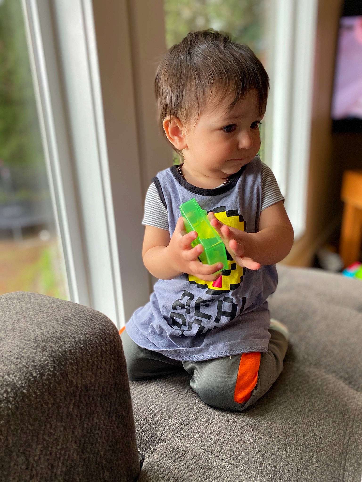 Denzel joined the competition — help win amazing prizes! baby, baby_toddler_clothing, cheek, child, comfort, facial_expression, flooring, fun, gadget, hairstyle, happy, knee, person, play, room, sitting, sleeve, smile, t_shirt, toddler