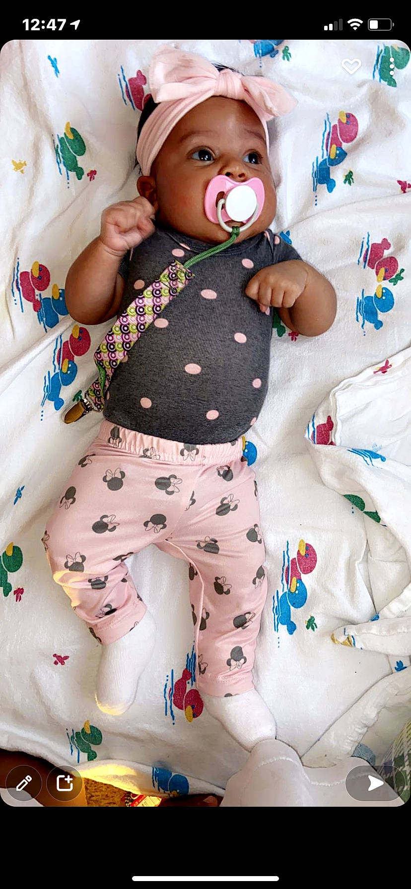 Dasani is registered to the contest to win money with this photo: arm, baby, baby_safety, baby_sleeping, baby_toddler_clothing, comfort, doll, face, green, happy, headwear, linens, pattern, person, pink, sleeve, stuffed_toy, textile, thigh, toddler