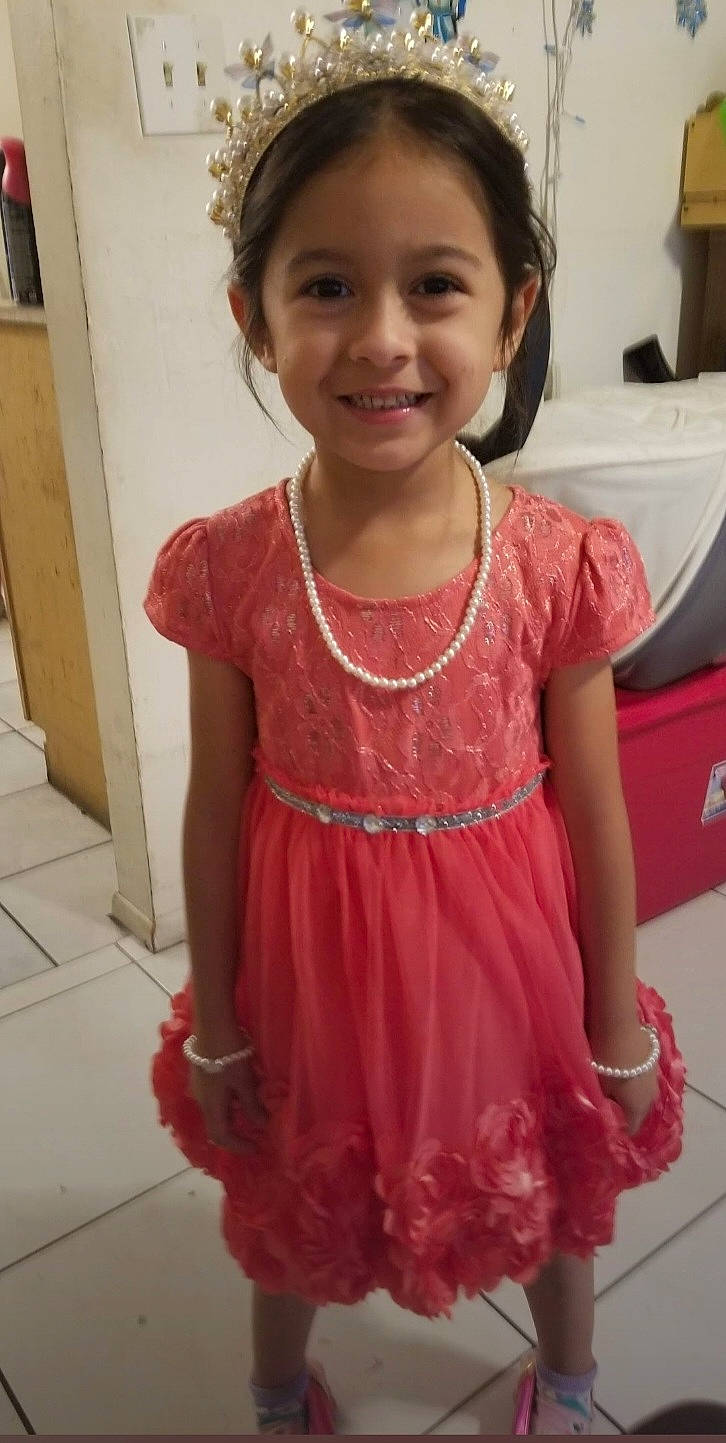 Roselina is registered to the contest to win money with this photo: child, day_dress, dress, embellishment, event, facial_expression, formal_wear, happy, head, jewellery, joy, magenta, neck, one_piece_garment, person, skin, sleeve, smile, standing, toddler