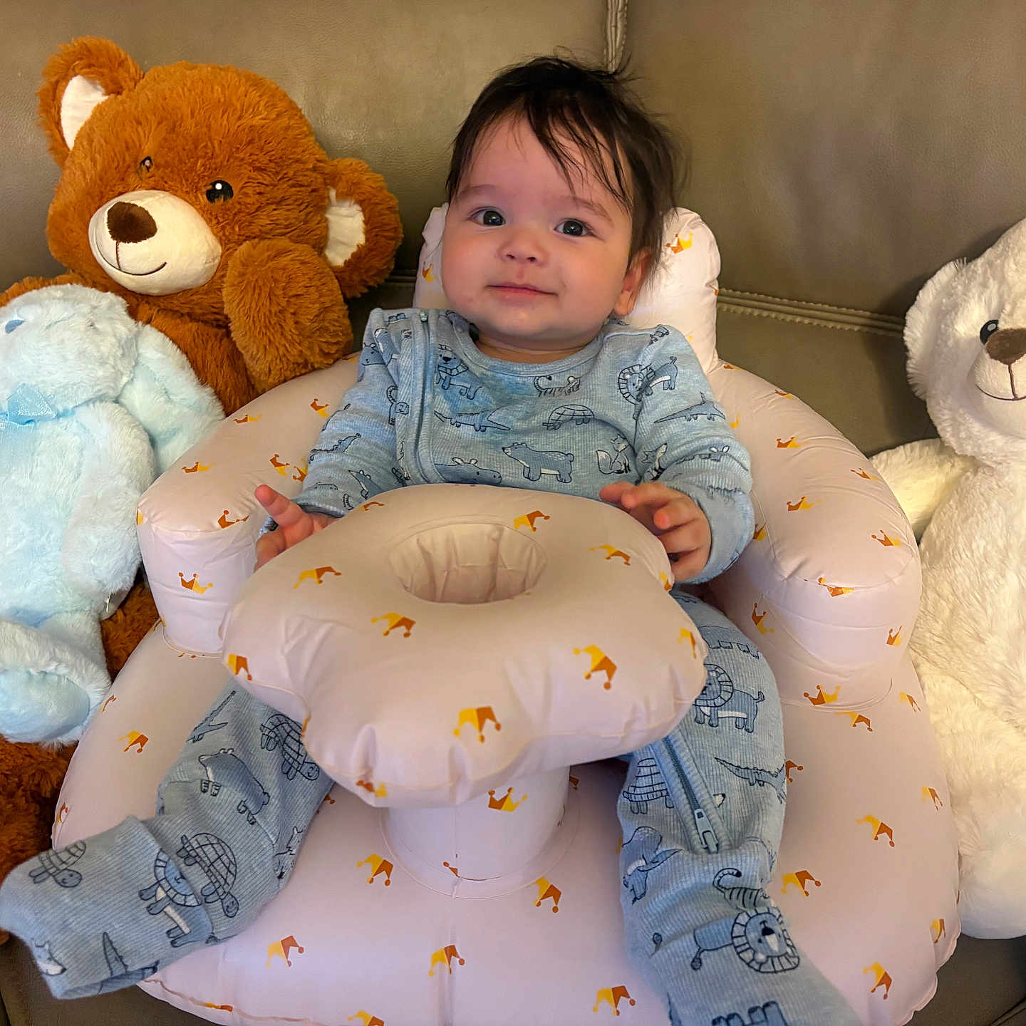 Ike is registered to the contest to win money with this photo: animal_print, baby, bear, blue_onesie, bunny, child, comfortable, couch, cute, hair, happy, indoors, infant, inflatable_seat, plush_toy, seat, smiling, soft_toys, stuffed_animal, toddler