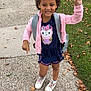 child, girl, outdoor, sidewalk, grass, leaves, pink_jacket, blue_outfit, owl_graphic, white_sneakers, peace_sign, pointing, smiling, curly_hair, backpack, casual_clothing, fall, daytime, happy, playful