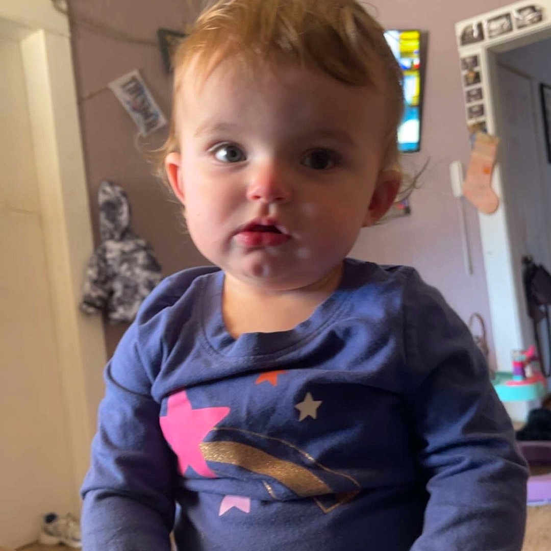 Charlotte Rork joined the competition — help win amazing prizes! blue_shirt, carpet, casual, child, coat, curious, doorway, face, furniture, hair, hands, home, indoor, long_sleeve, person, picture_frame, portrait, seated, toddler, young_child