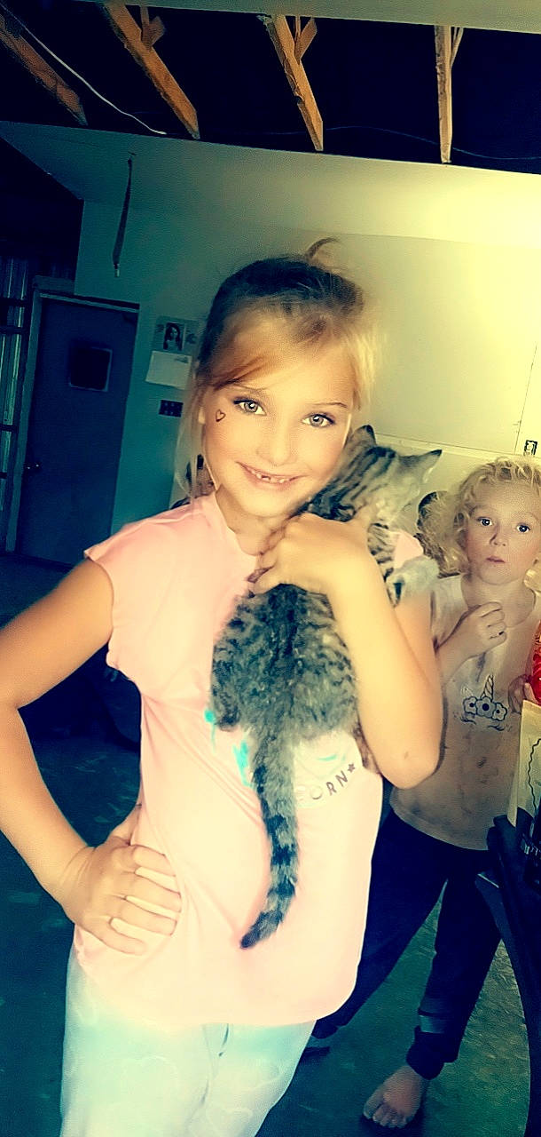 Annabella is registered to the contest to win money with this photo: arm, black_hair, carnivore, cat, cool, door, facial_expression, fawn, felidae, finger, gesture, hair, happy, iris, joy, neck, person, skin, small_to_medium_sized_cats, smile