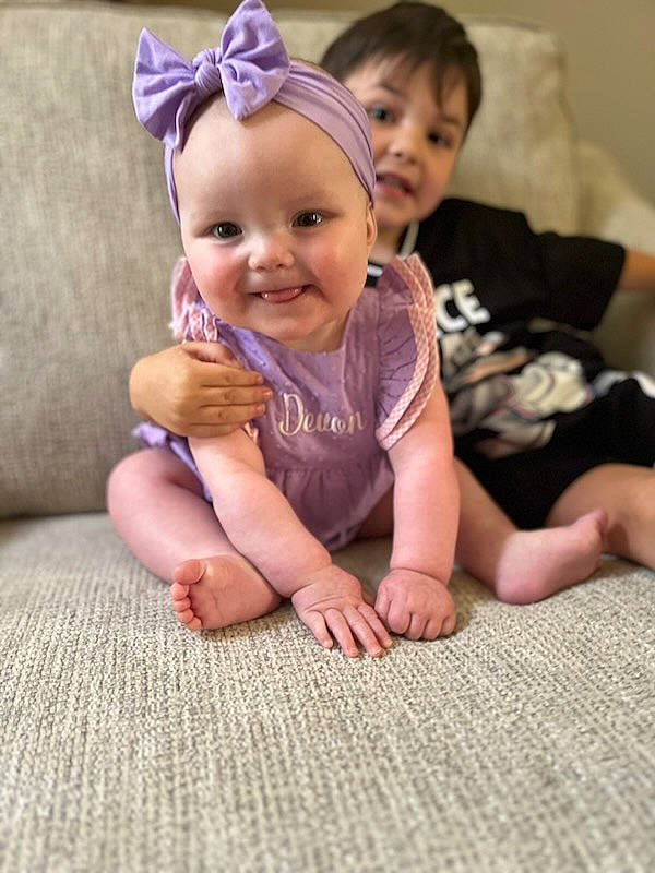 Devon joined the competition — help win amazing prizes! baby, baby_toddler_clothing, barefoot, cheek, child, comfort, facial_expression, finger, floor, flooring, gesture, happy, joy, leg, mammal, person, pink, skin, smile, thumb