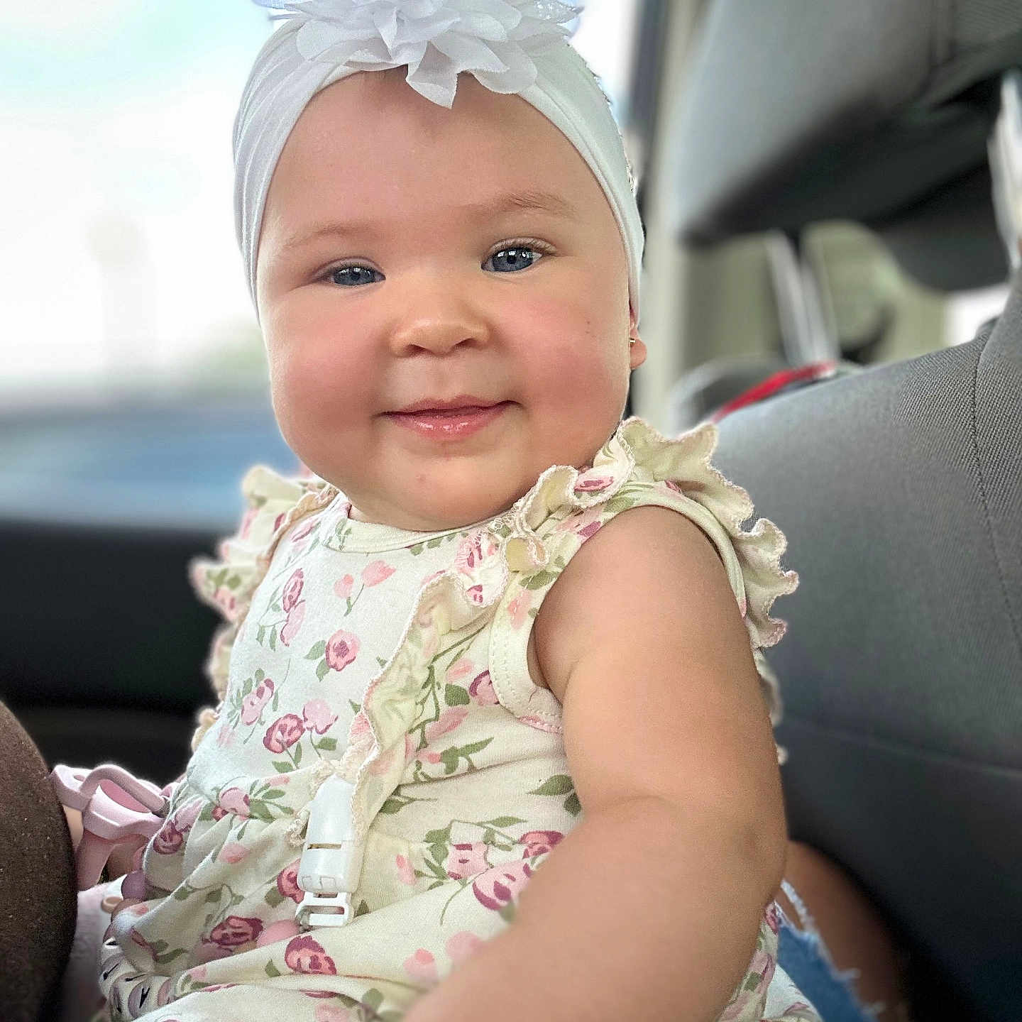 Cattaleya joined the competition — help win amazing prizes! arm, baby, car_seat, cheeks, child, clothing, dress, floral, flower, happy, headband, indoor, person, portrait, ruffles, seat, seatbelt, skin, smile, window