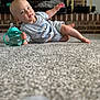 Jaxxon joined the competition — help win amazing prizes! baby, child, carpet, floor, sippy_cup, grey_clothing, indoor, fireplace, brick, person, cute, infant, holding, toy, relaxed, portrait, head, face, looking, casual