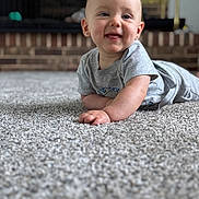 Jaxxon joined the competition — help win amazing prizes! baby, child, smiling, carpet, gray_shirt, indoor, face, tongue_out, cute, happy, infant, person, home, floor, portrait, young_child, earrings, crawling, soft_texture, background_blur