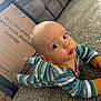 Jaxxon is registered to the contest to win money with this photo: baby, child, infant, striped_onesie, carpet, cardboard_box, blue_eyes, earrings, curious_expression, floor, living_room, couch, home, indoor, person, cute, toddler, pursed_lips, side_eye, playtime
