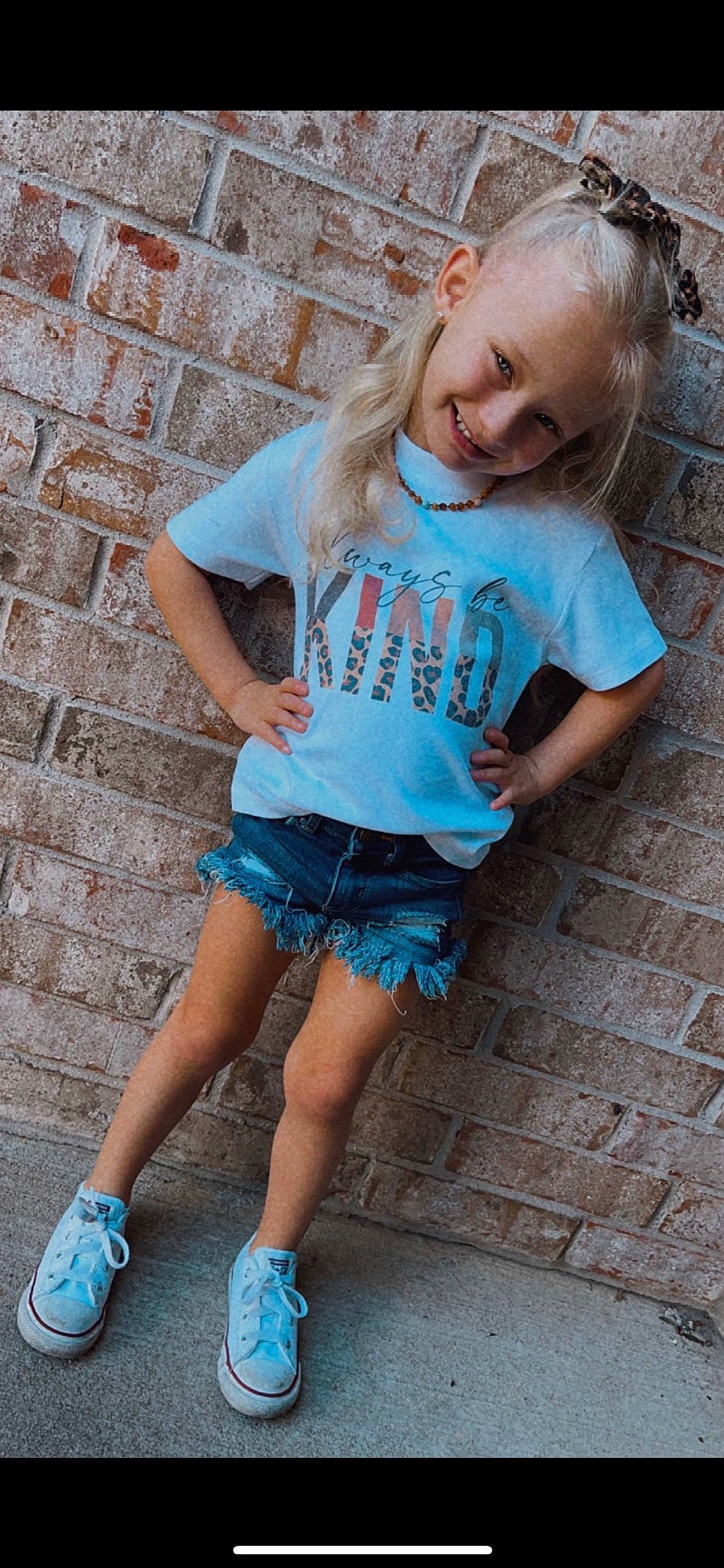 Kinsley is registered to the contest to win money with this photo: eye, face, green, hair, hairstyle, happy, head, human, joint, joy, leg, person, photograph, pink, shoe, shoulder, sleeve, smile, standing, t_shirt